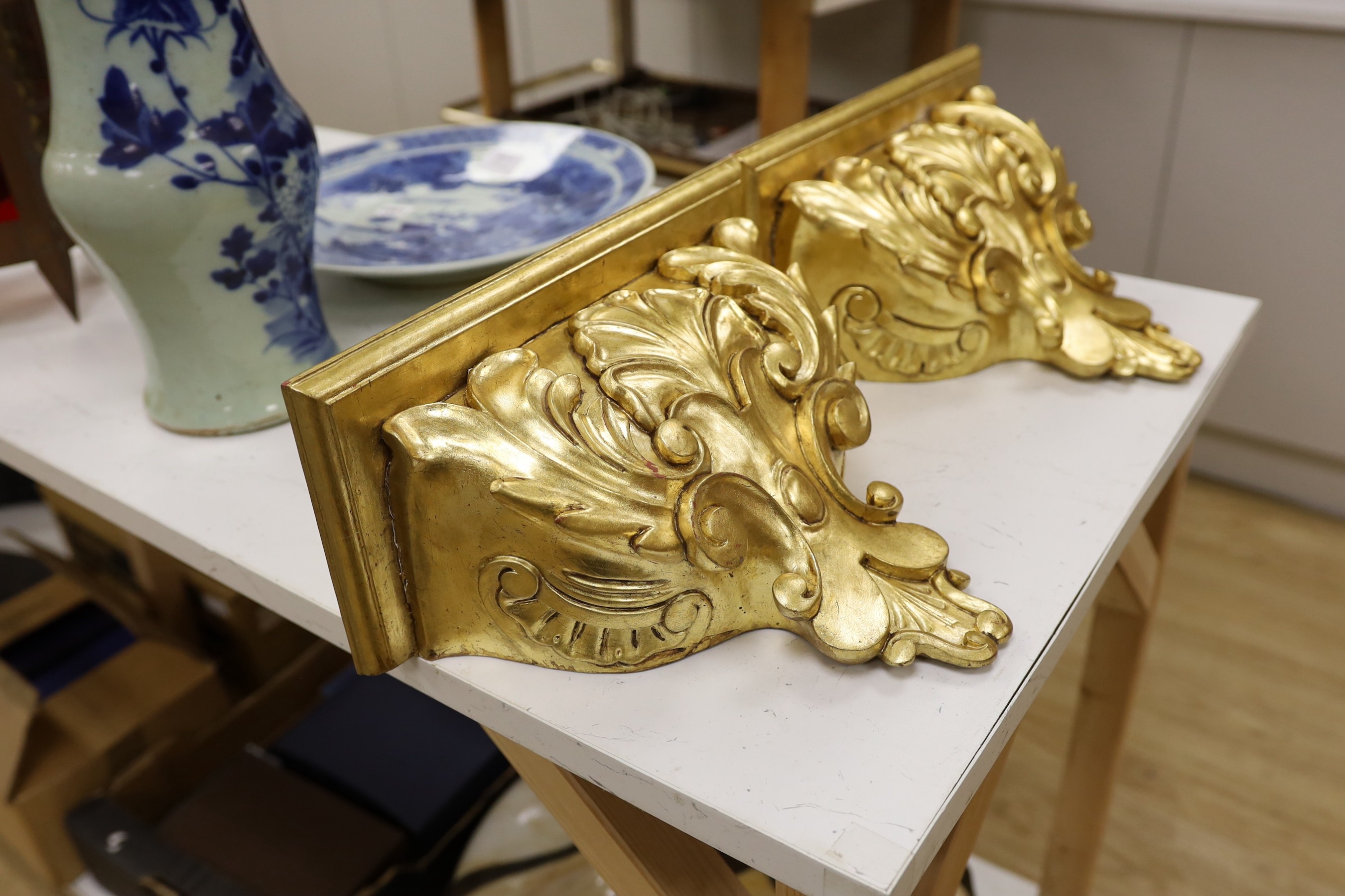 A pair of gilt wood wall brackets